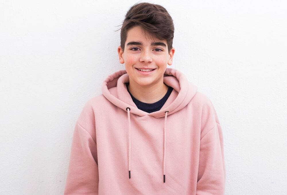 Photo of a teenager wearing a pink hoodie