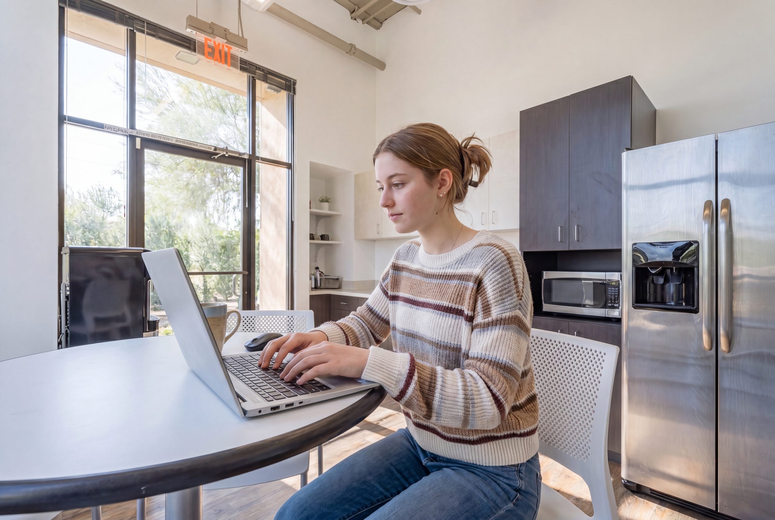 girl on computer at kitchen table