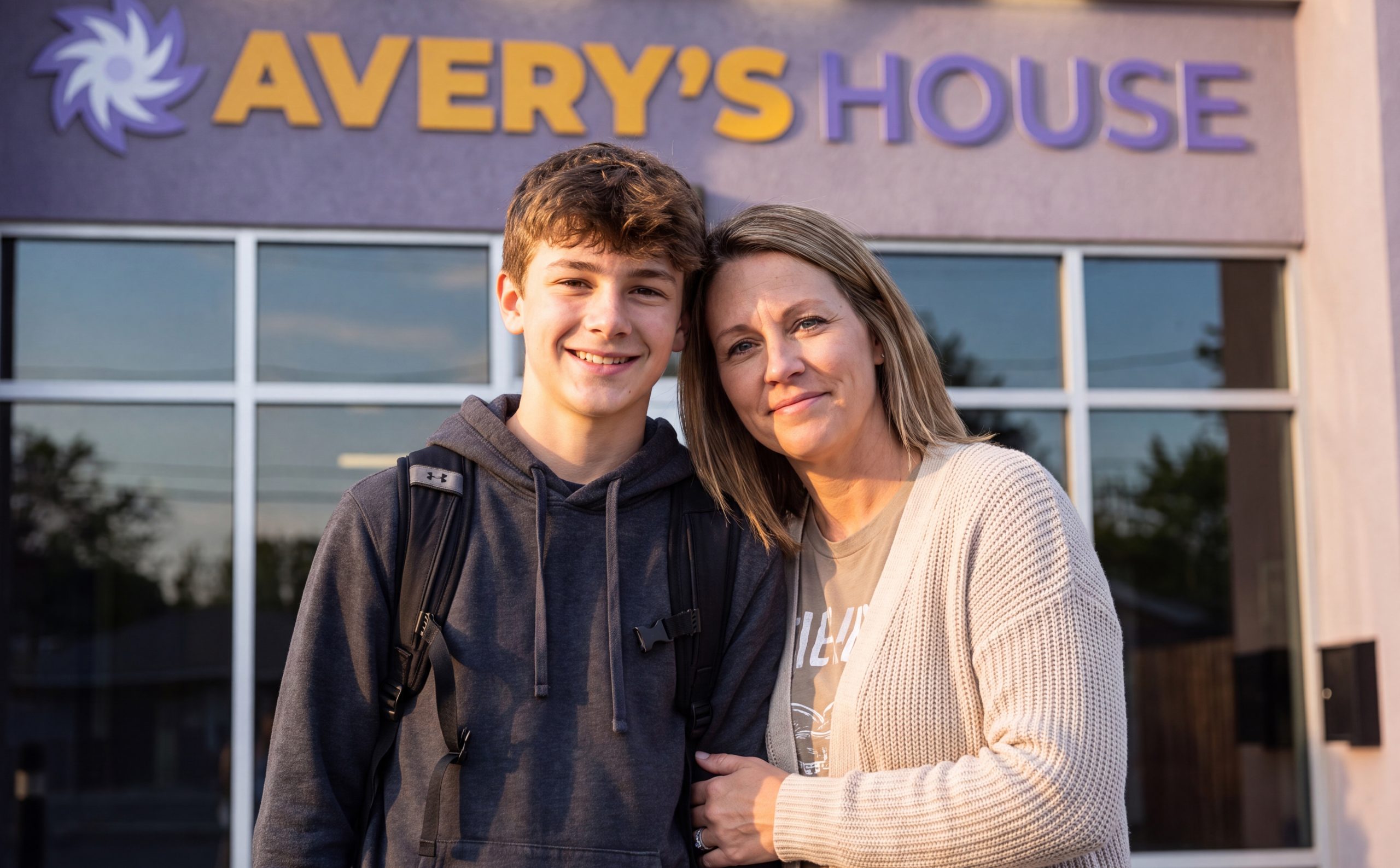 mother and teenage son in front of Avery's House